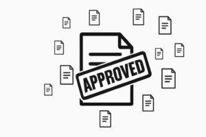 Approved document concept with a stamp on a file icon surrounded by other document icons. Represents confirmation and acceptance.